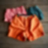 A selection of vibrant plus size vintage shorts showcasing different patterns and textures on a rustic wooden surface.