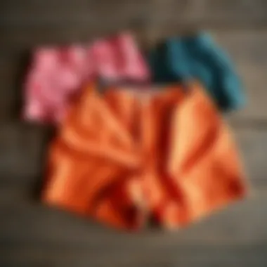 A selection of vibrant plus size vintage shorts showcasing different patterns and textures on a rustic wooden surface.