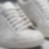 Close-up view of white tabi sneakers showcasing unique stitching and design.